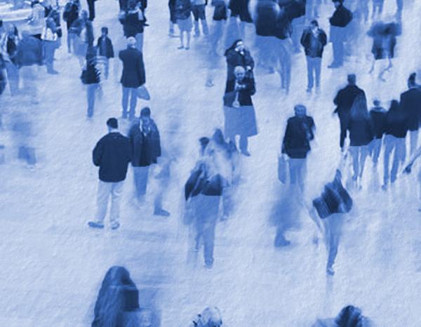 Blurred image of people walking in a crowded space